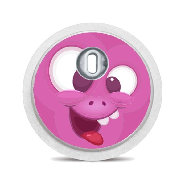 Runder Aufkleber mit pinkem Monstergesicht. Zunge, Auge, Zähne. Mit silbernem Applikator.