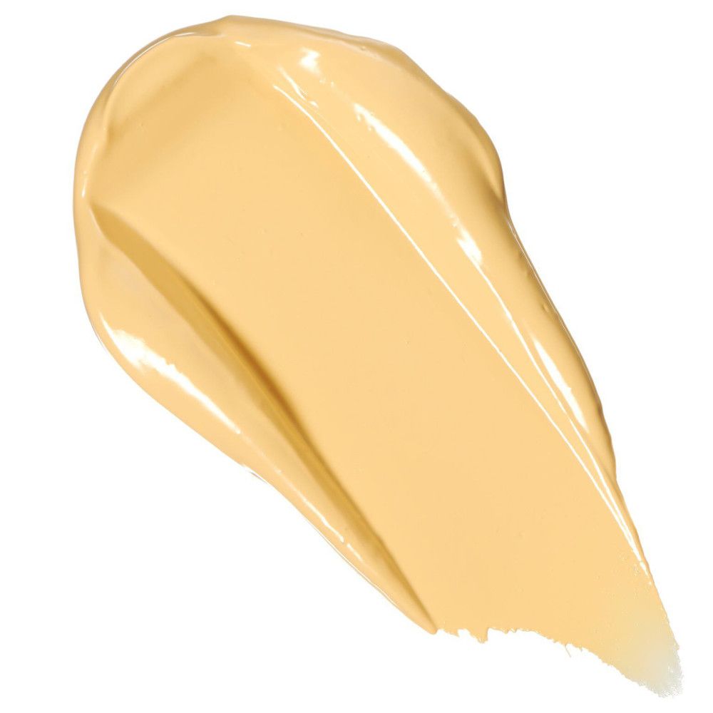 Gelber Concealer-Strich. Glänzende Textur. Unregelmäßige Form.