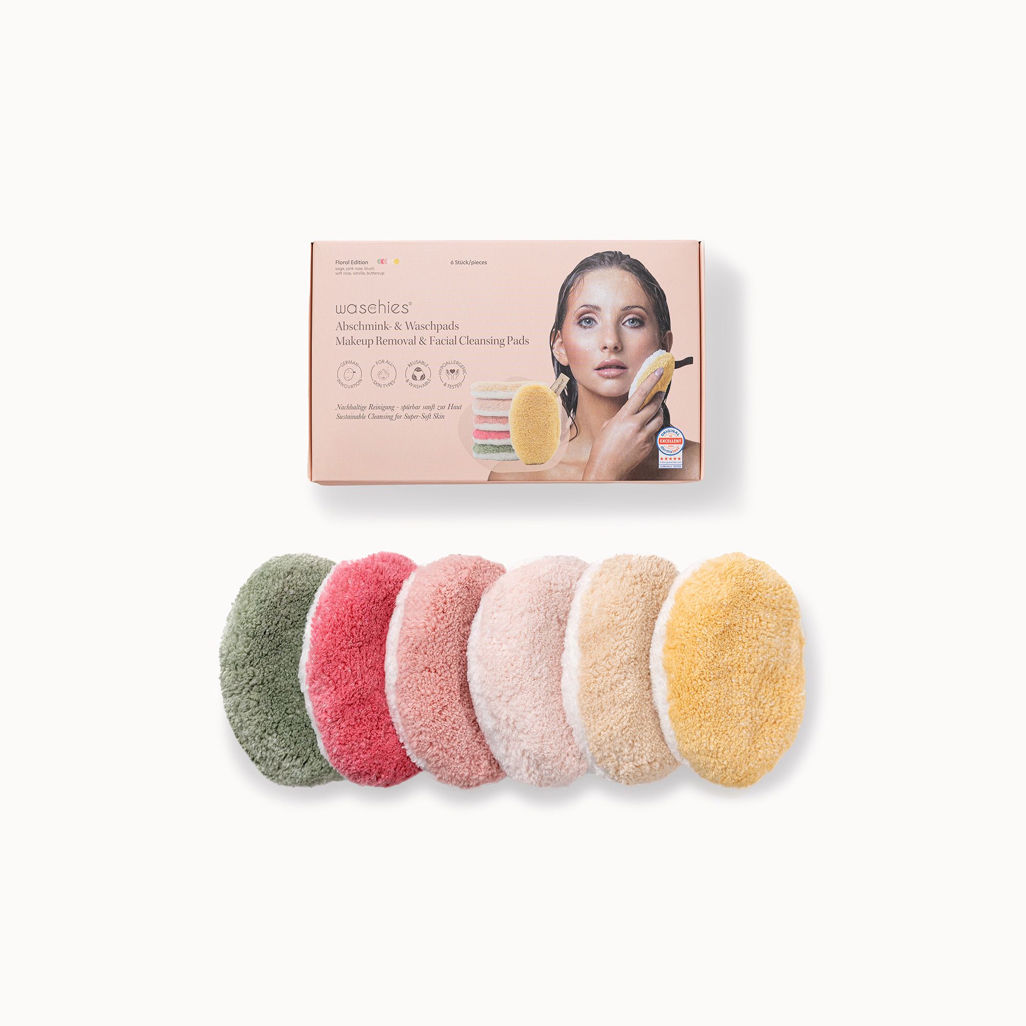 Verpackung mit sechs Abschminkpads in Pastellfarben. Pads: Grün, Rot, Rosa, Beige, Gelb. Box mit Produktabbildung.