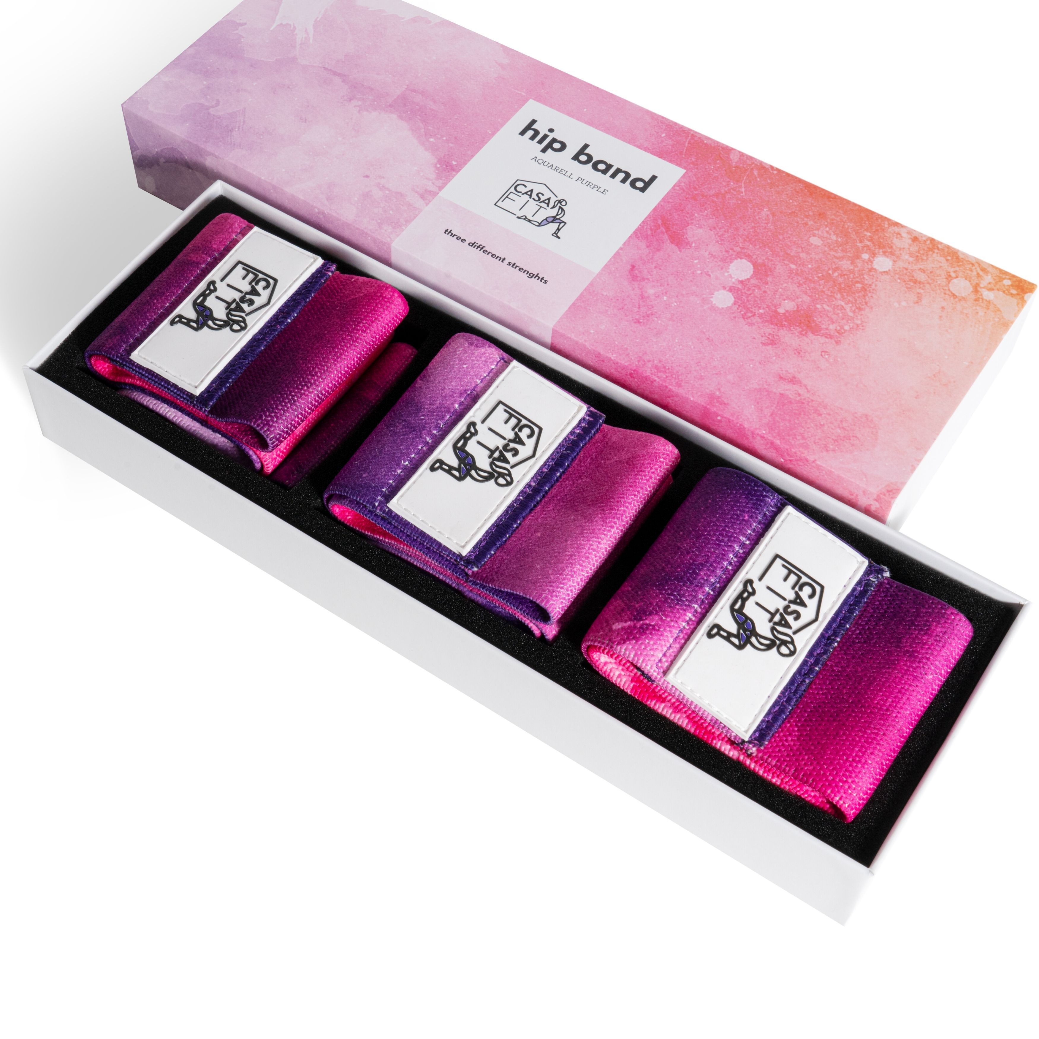 Drei CASAFIT Hip Bands in einer Box. Rosa-lila Farbverlauf. CASAFIT Logo auf den Bändern.