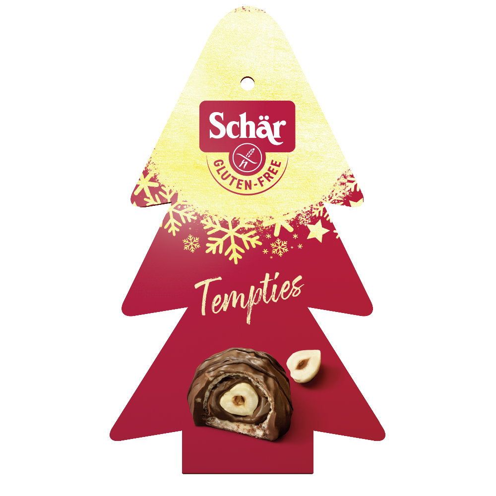 Weihnachtsbaum-Verpackung mit Schär-Logo und "Gluten-Free"-Symbol. Darunter Tempties-Schokolade mit Haselnuss.