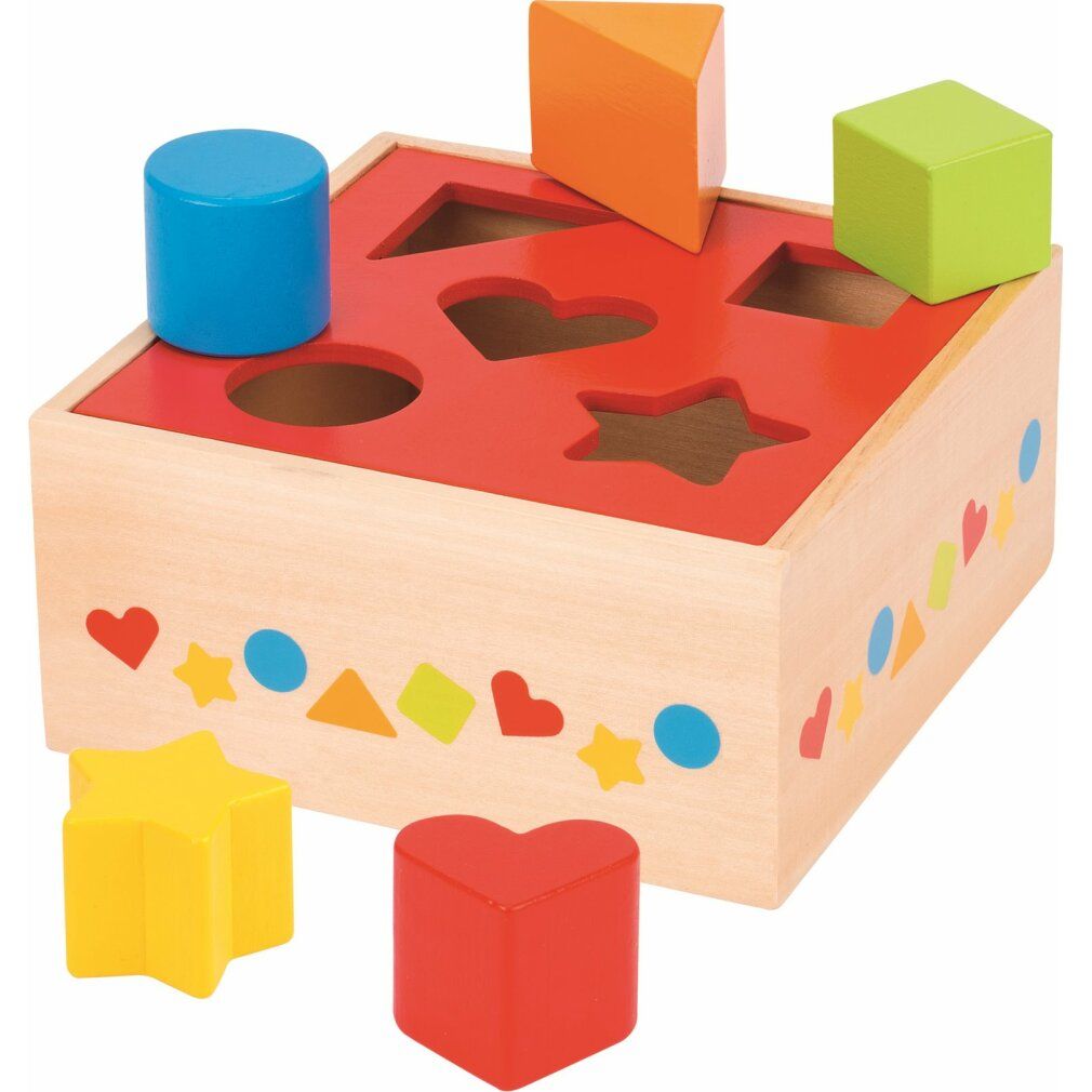 Holzkiste mit farbigen Formen zum Einsetzen. Rote Oberseite mit Aussparungen. Mehrere Formen daneben.