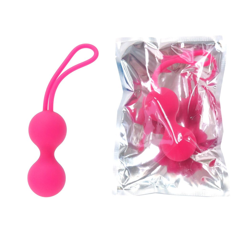 Zwei rosa Kugeln mit Schlaufe, neben einer Verpackung. Die Kugeln sind aus Silikon. Die Verpackung ist durchsichtig.