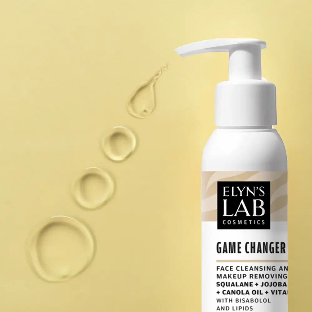 Weiße Flasche mit Pumpe. Etikett "ELYN'S LAB" und "Game Changer". Daneben Öltropfen auf gelbem Hintergrund.