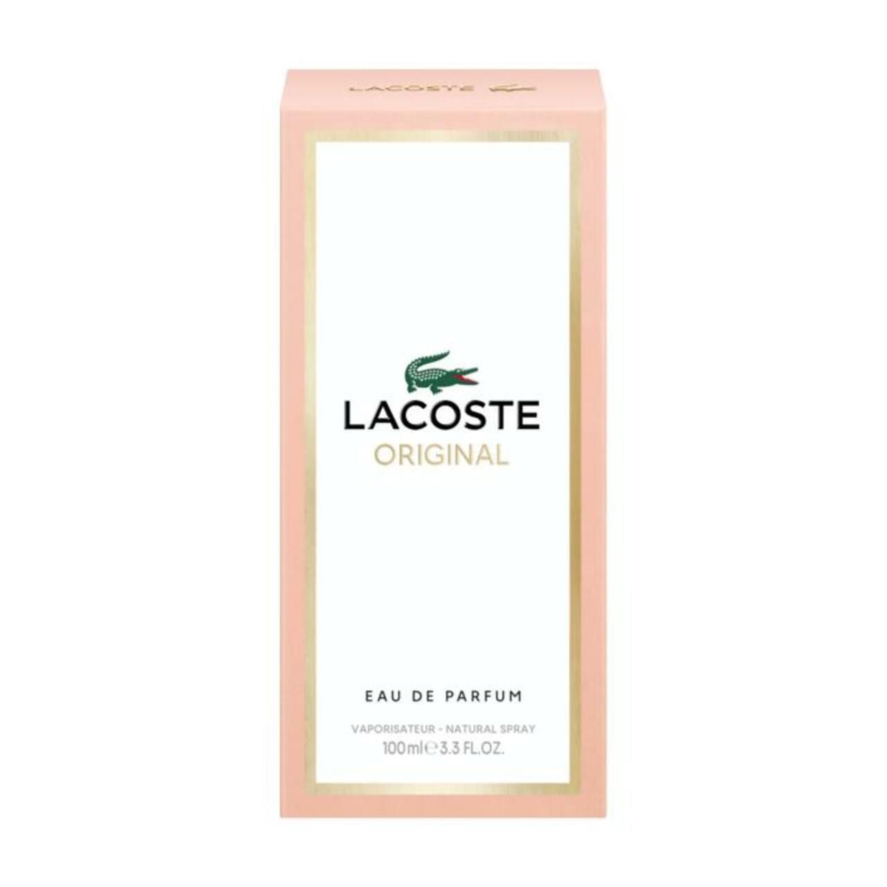 LACOSTE Original Femme EdP Nat. Spray Verpackung. Rosa Karton mit weißem Etikett, goldenen Akzenten und Krokodil-Logo.