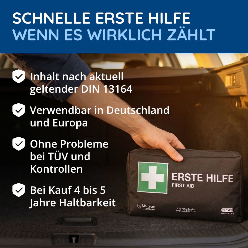 Schwarze KFZ-Verbandtasche mit grünem Kreuz und Aufschrift "ERSTE HILFE". Geöffnet im Kofferraum. Malteser-Logo.