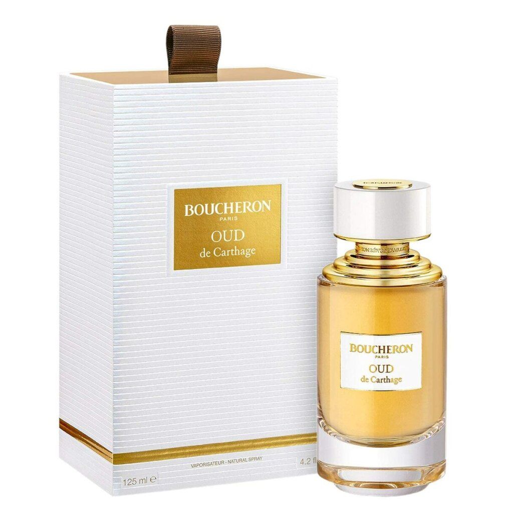 Parfümflasche und Verpackung. Flasche mit goldener Kappe und gelber Flüssigkeit. Verpackung mit goldenem Etikett.