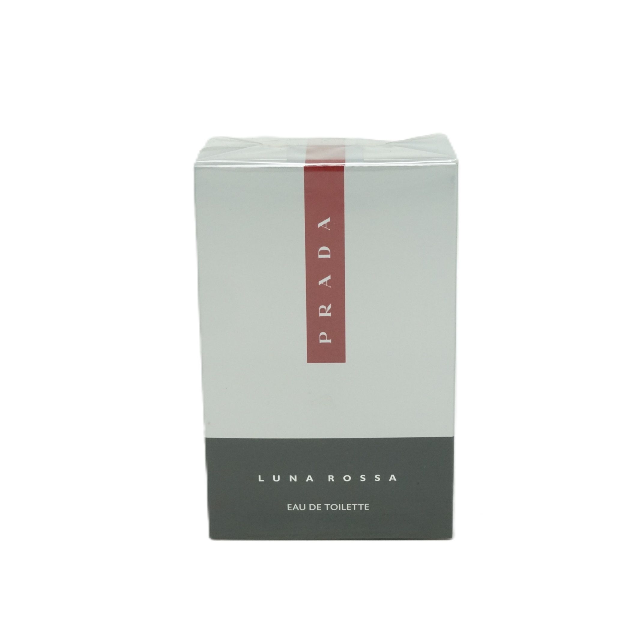Verpackung von Prada Luna Rossa Eau de Toilette. Weißer Karton mit rotem Streifen und Prada-Logo. Grauer Sockel mit Produktbezeichnung.