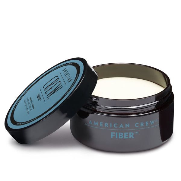Dunkelgraue Dose mit blauem Deckel. Deckel mit Produktbezeichnung. Geöffnete Dose mit cremiger Substanz.