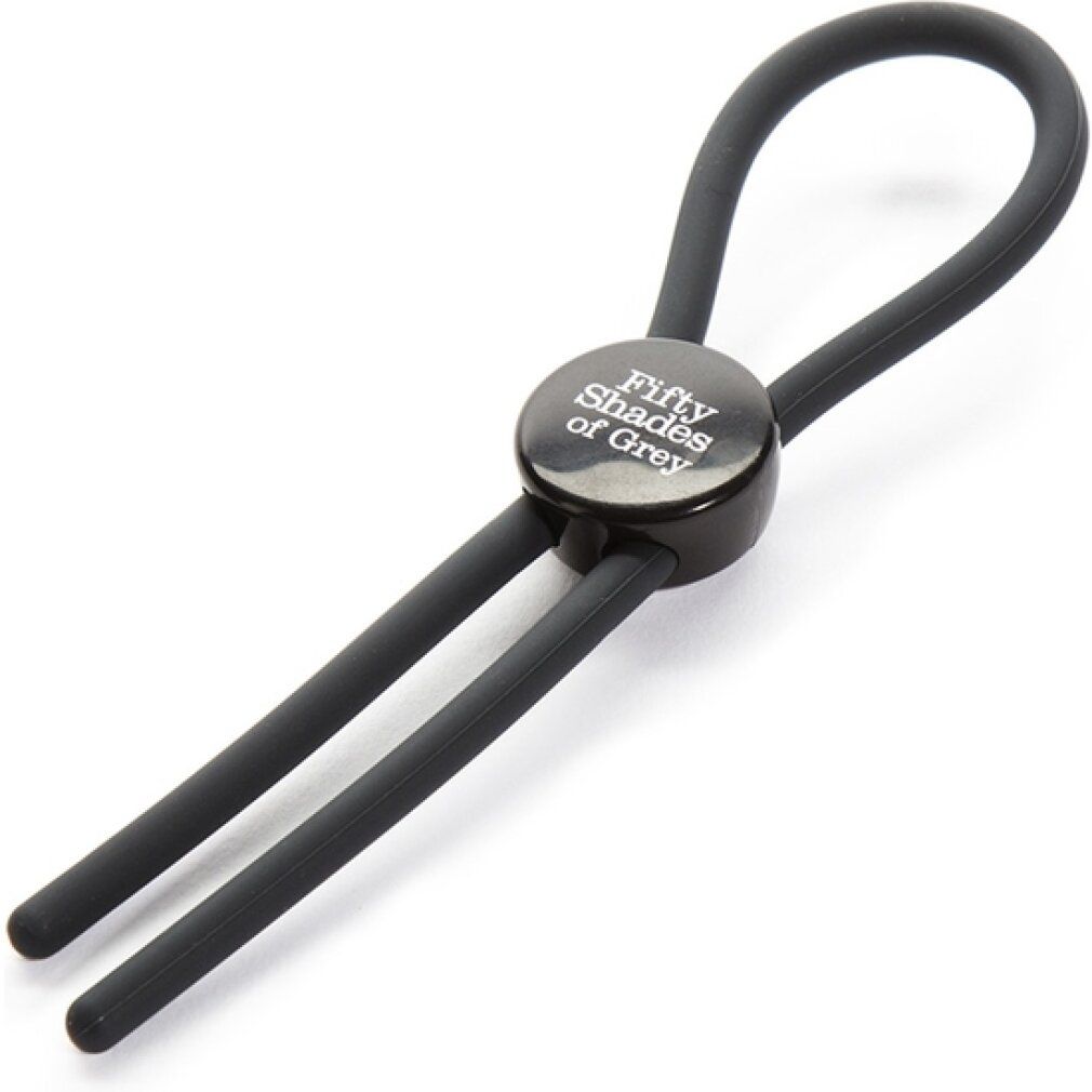 Dunkelgraue Penisschlaufe mit rundem Mittelteil und Schriftzug. Zwei Stränge und ein Ring bilden die Form.