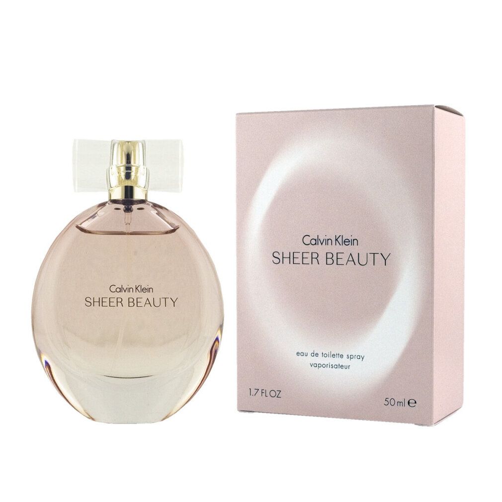 Parfümflasche und Verpackung. Aufschrift: Calvin Klein Sheer Beauty. Flasche rund, rosa Flüssigkeit.