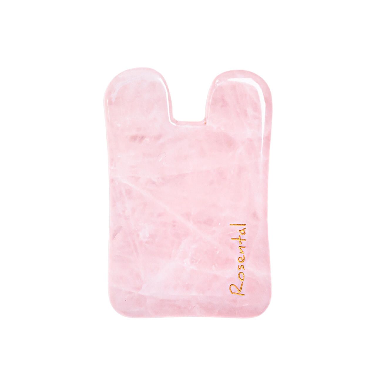 Rosental Organics Gua Sha aus Rosenquarz. Rosa, rechteckig mit abgerundeten Kanten und einer Kerbe.