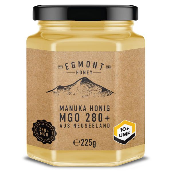 Glas Honig mit schwarzem Deckel. Auf dem Etikett steht "EGMONT HONEY", "MANUKA HONIG MGO 280+" und "AUS NEUSEELAND".