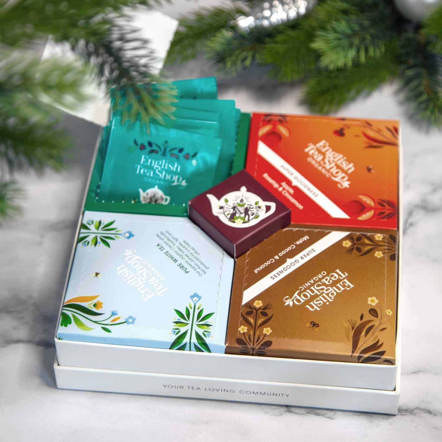 Tee-Geschenkbox mit 4 Sorten Teebeuteln. Aufschrift "English Tea Shop". Verschiedene Farben und Designs.