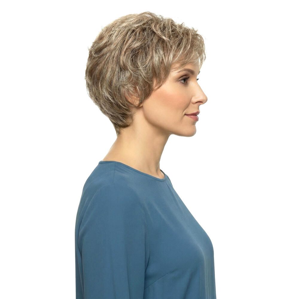 Kurzhaarperücke in Blondtönen. Seitenansicht einer Frau mit blauem Oberteil. Natürlicher Look, gewellt.