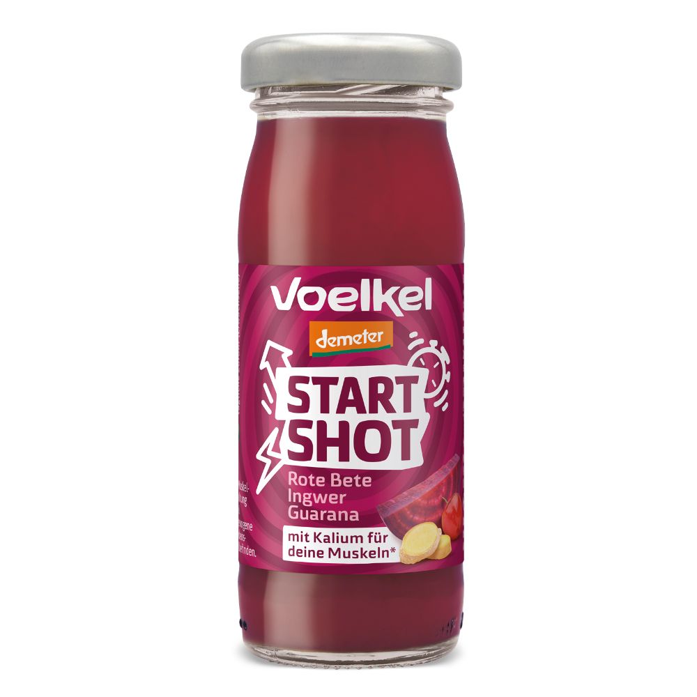 Glasflasche mit rotem Saft. Etikett mit "Voelkel", "Start Shot", "Rote Bete Ingwer" und "Demeter"-Logo. Grauer Deckel.