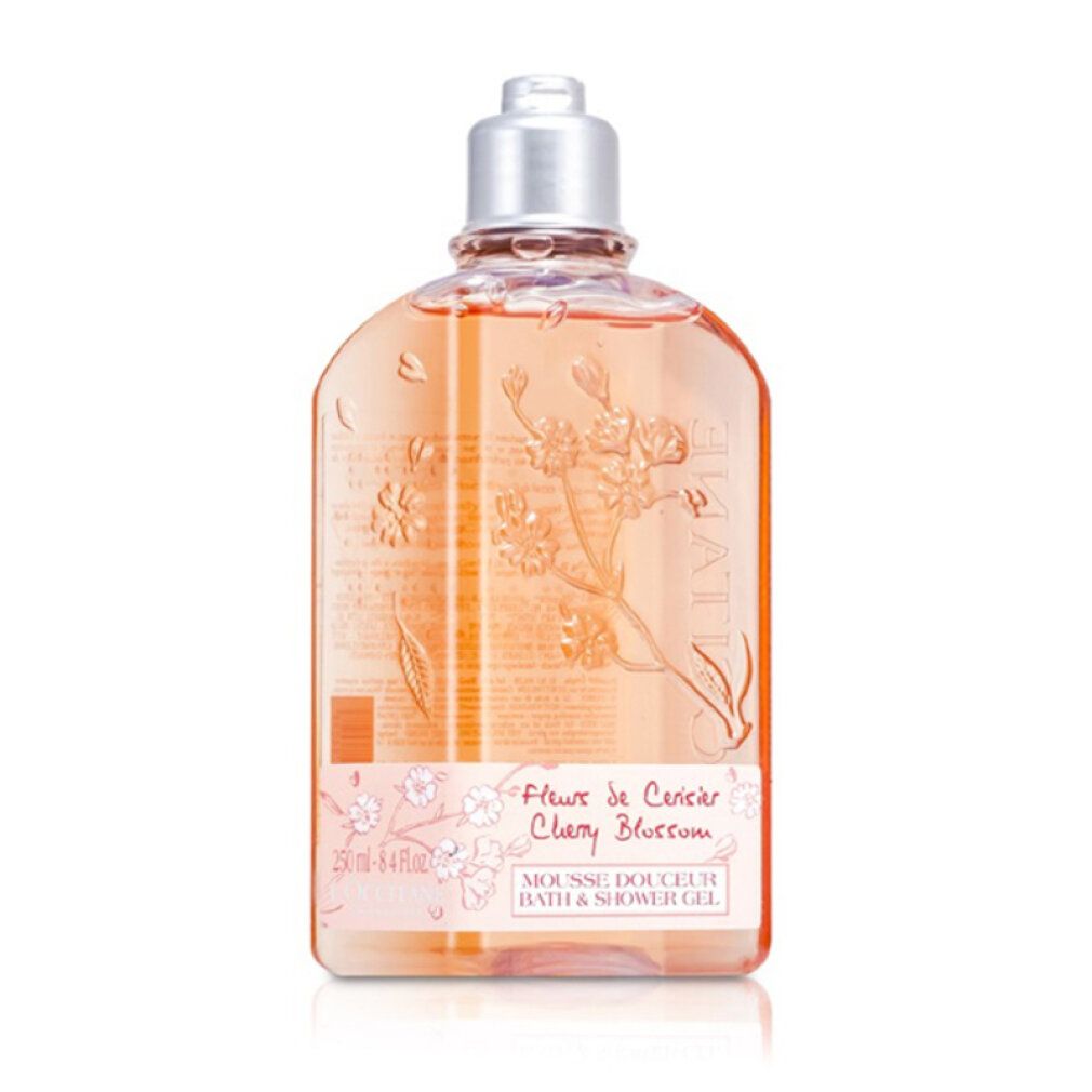 Transparente Duschgelflasche mit Kirschblüten-Design. Text: "Fleur de Cerisier Cherry Blossom". Marke sichtbar.