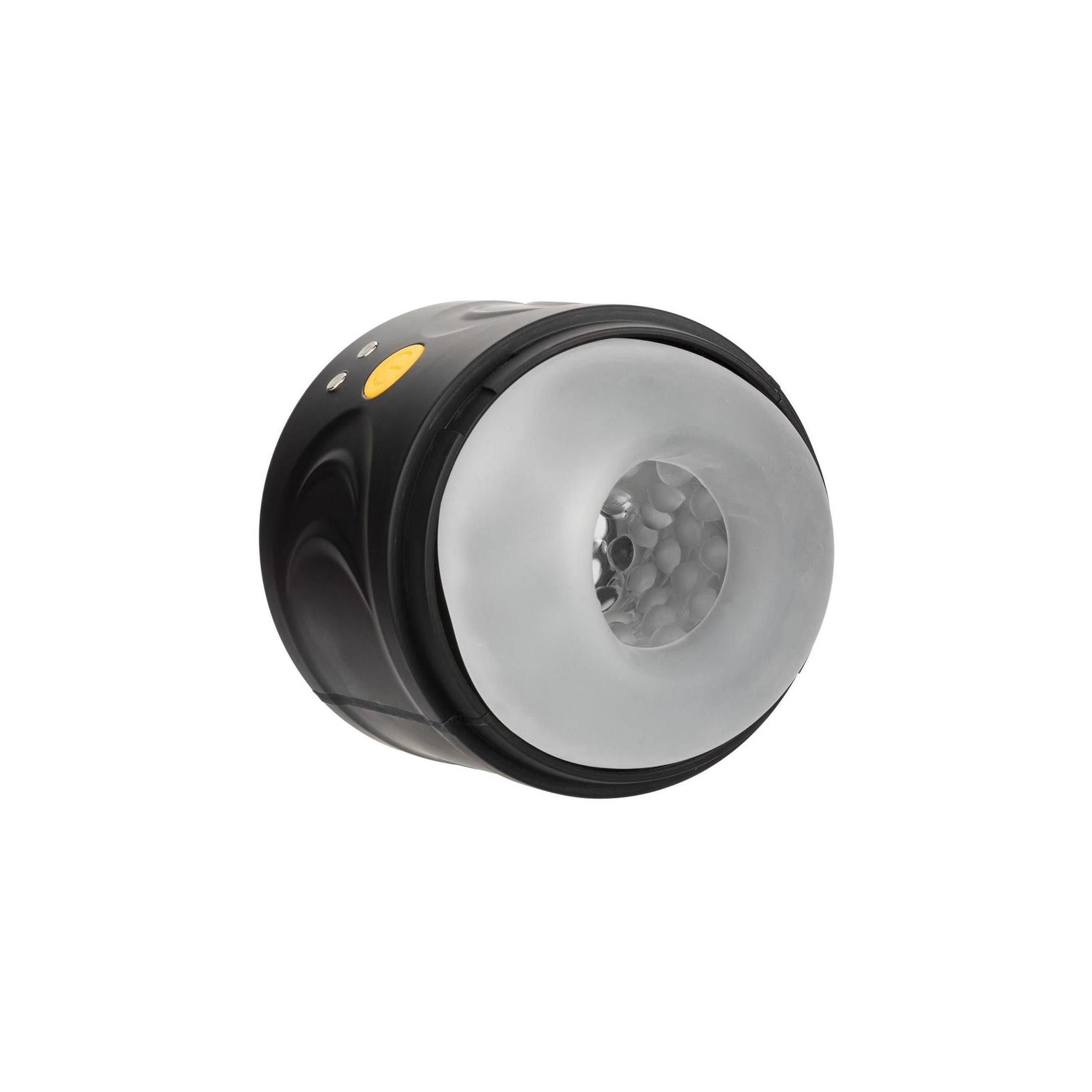 Schwarzes Gerät mit weißem Innenraum. Gelber Knopf und zwei kleine Knöpfe. Geformt für Intimität.