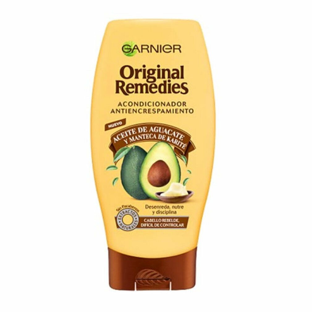 Gelbe Flasche mit Garnier Original Remedies Avocado-Conditioner. Avocado- und Sheabutter-Illustration. Text: 'Acondicionador Antiencrespamiento'.