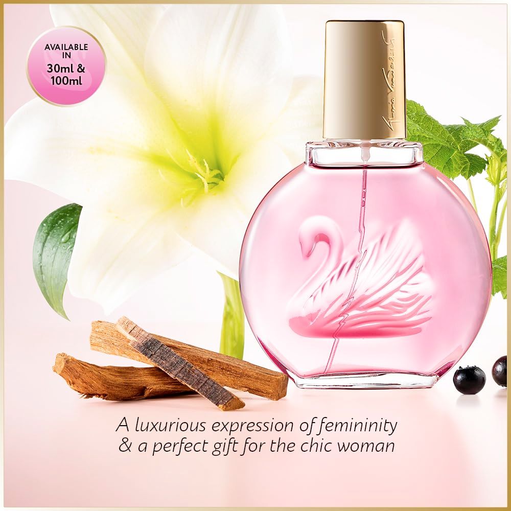 Rosa Parfumflasche mit goldenem Verschluss, Schwanenmotiv. Hintergrund mit Blumen und Holz.