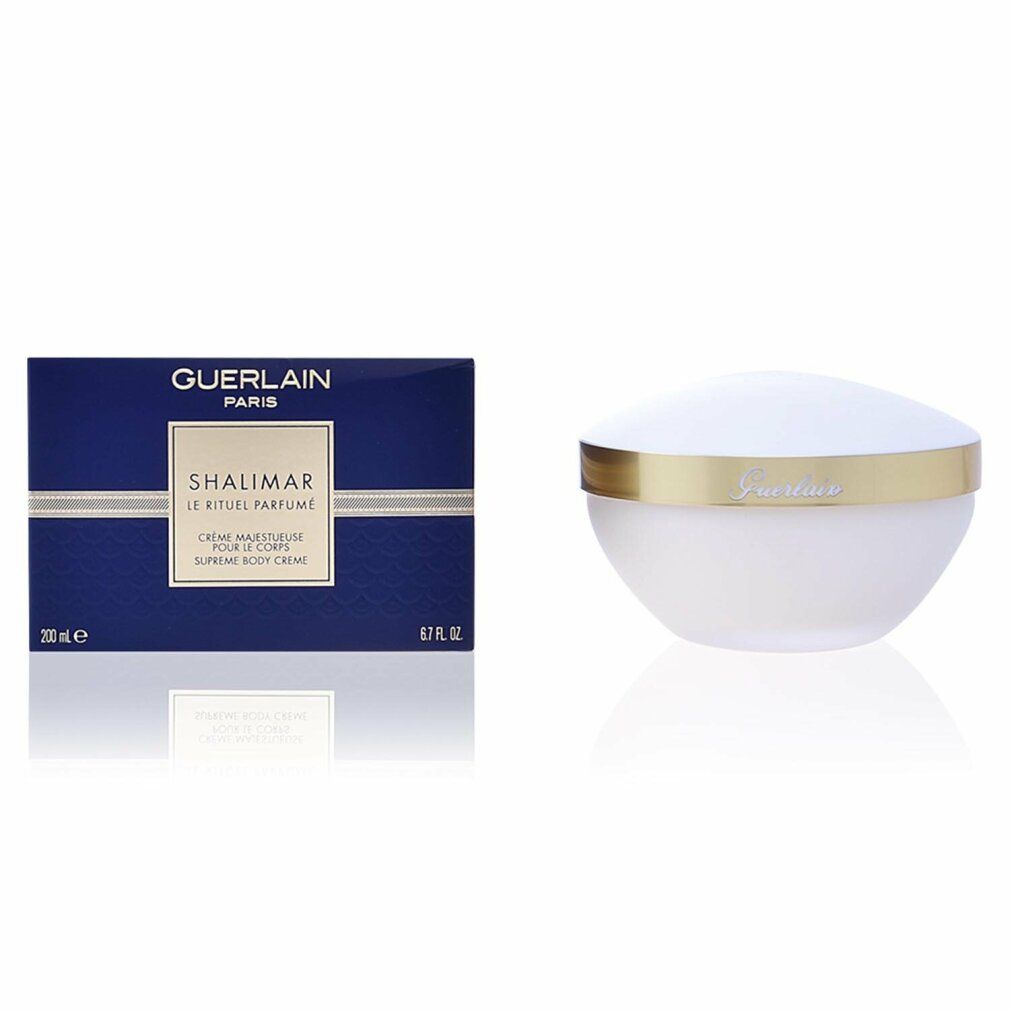 Produktverpackung und Cremebehälter. Verpackung: dunkelblaue Schachtel mit goldfarbenem Etikett. Creme: weißes Gefäß mit goldenem Rand.