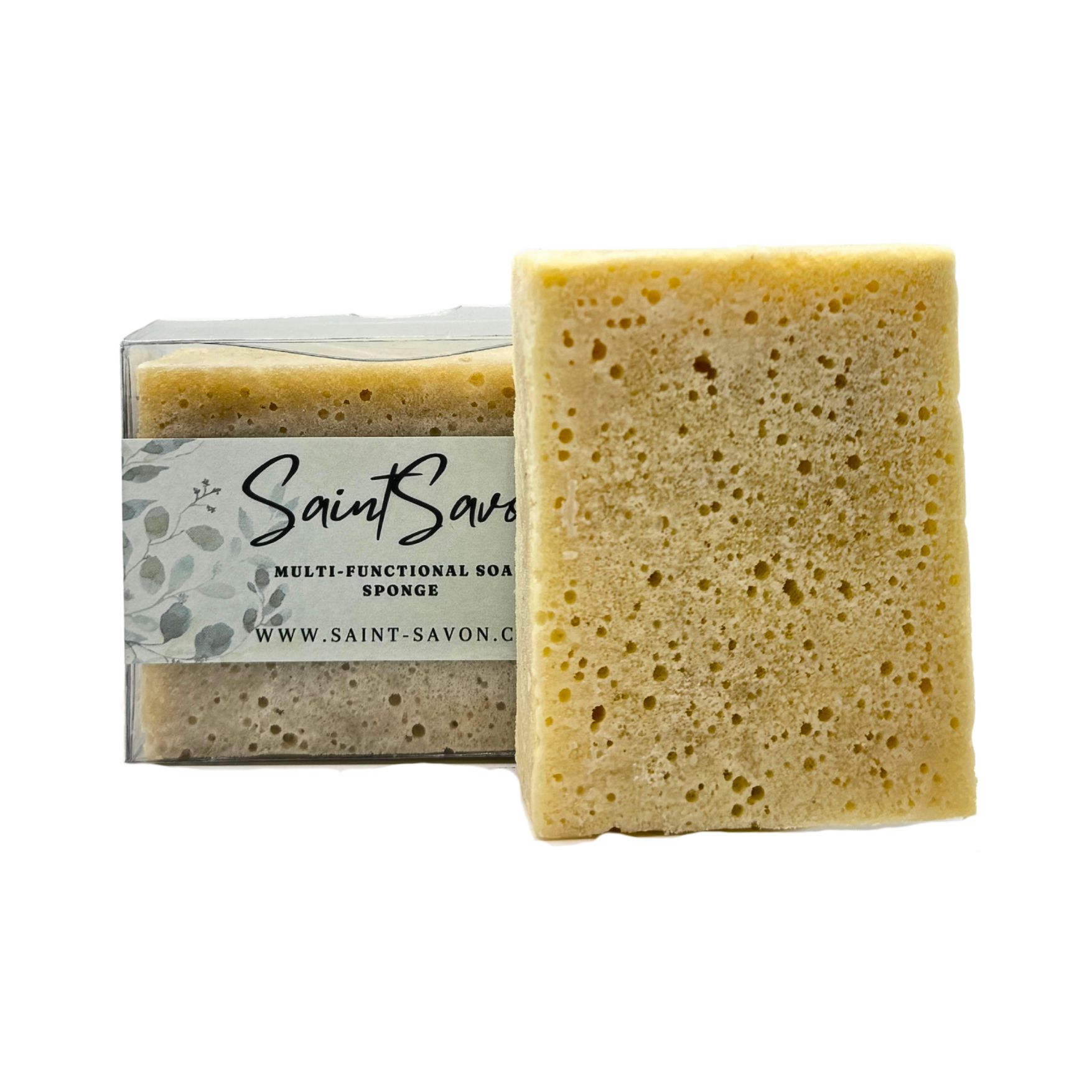 Rechteckige Schwämme, einer in Verpackung, einer daneben. Auf dem Etikett steht "Saint Savon", "Multi-Functional Soap Sponge" und die Website.