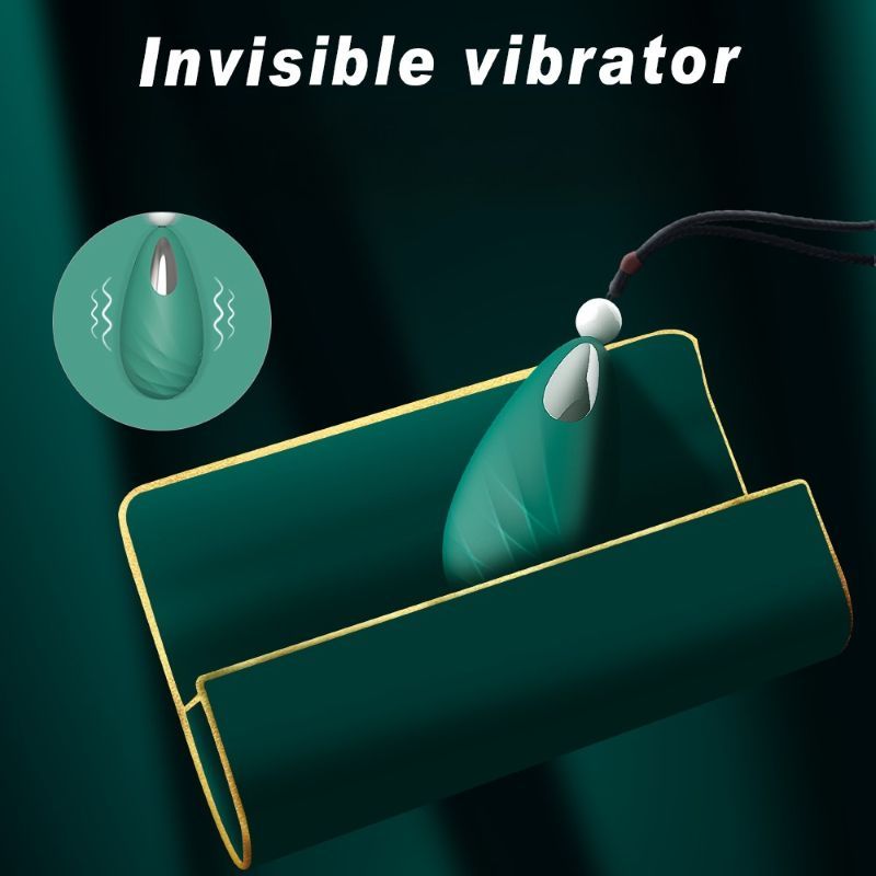 Grünes, tropfenförmiges Produkt in Halterung. Weißer Ball und schwarzes Band. Text: Invisible vibrator.