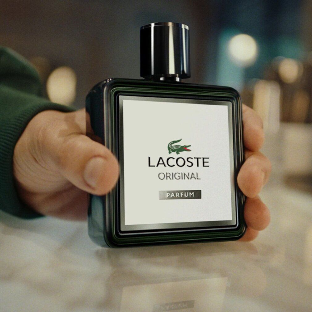 LACOSTE Original Parfum Flakon mit schwarzem Verschluss und grünem Rahmen.