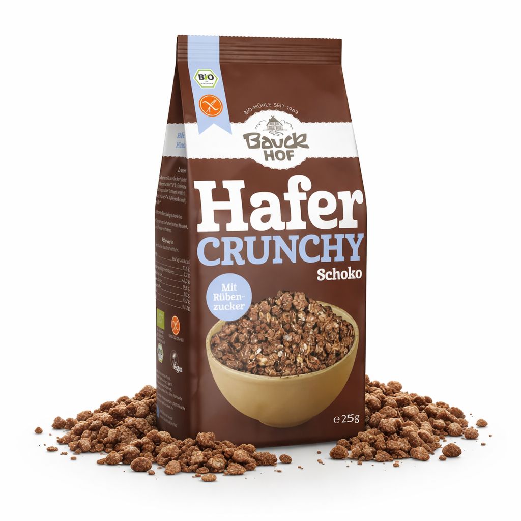 Bauckhof Hafer Crunchy Schoko glutenfrei Müsli in brauner Packung, umgeben von verstreutem Müsli.
