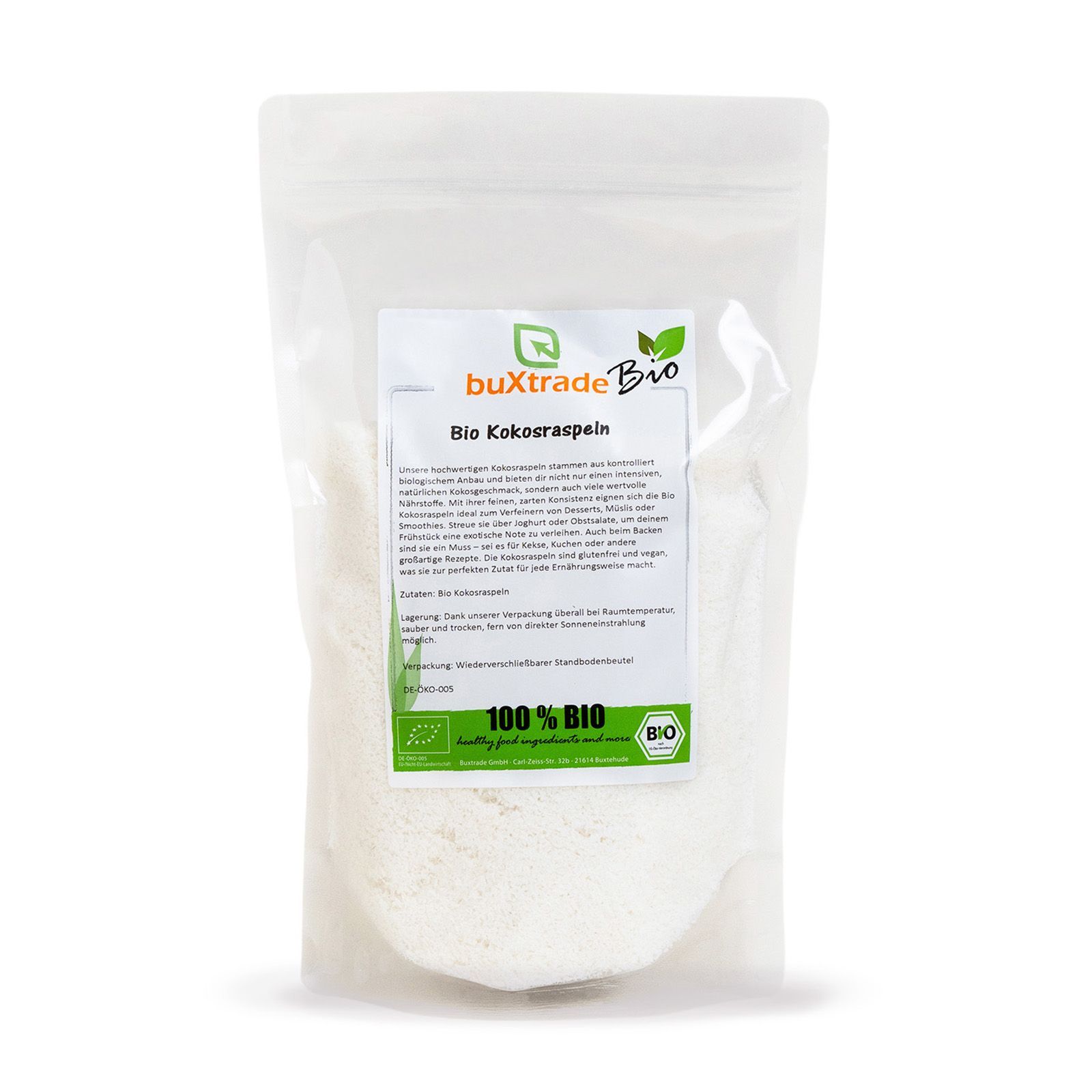 Transparente Verpackung mit buXtrade Bio Kokosraspeln. Produktname, Text, Bio-Siegel. Weiße Kokosraspeln.