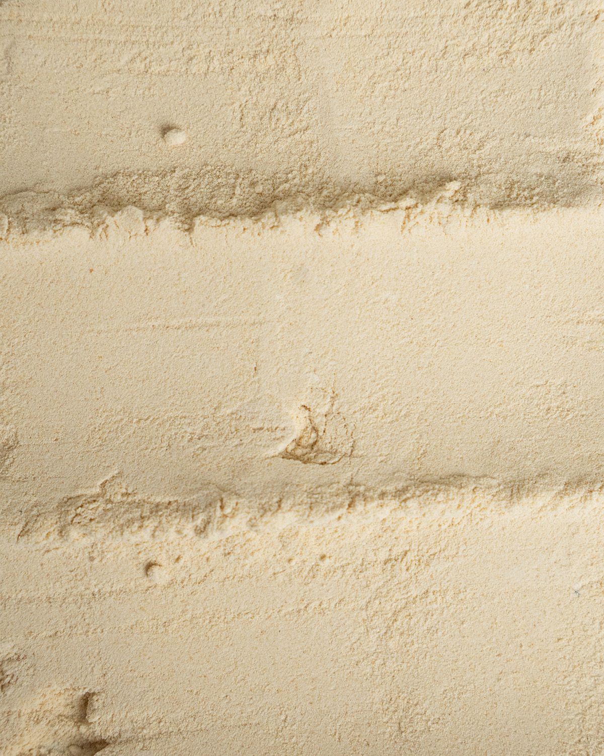 Nahaufnahme von Soja Lecithin Pulver mit Streifen.