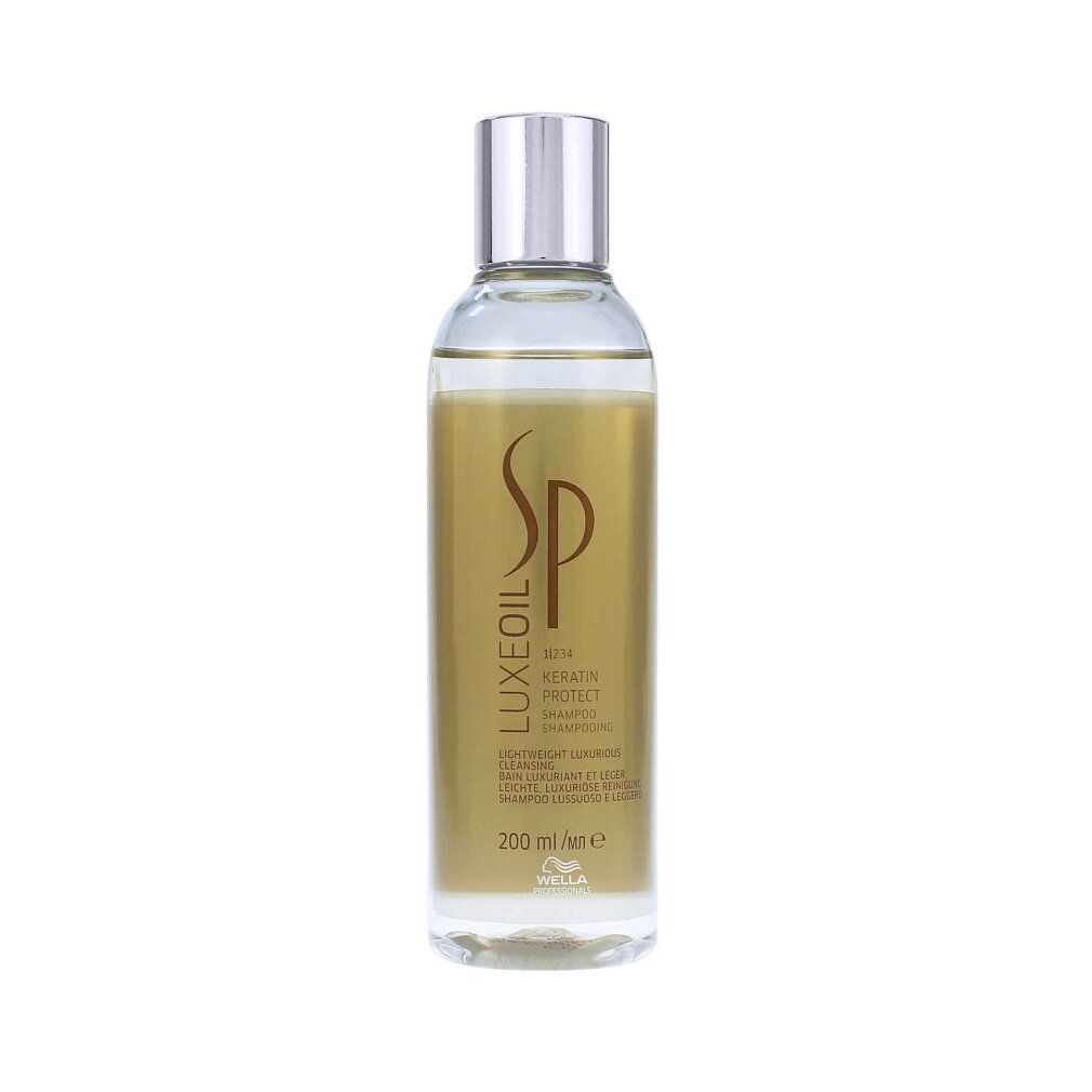 Wella SP Luxe Oil Shampoo. Transparente Flasche mit goldfarbener Flüssigkeit. Silberner Deckel. Produktetikett mit Text.