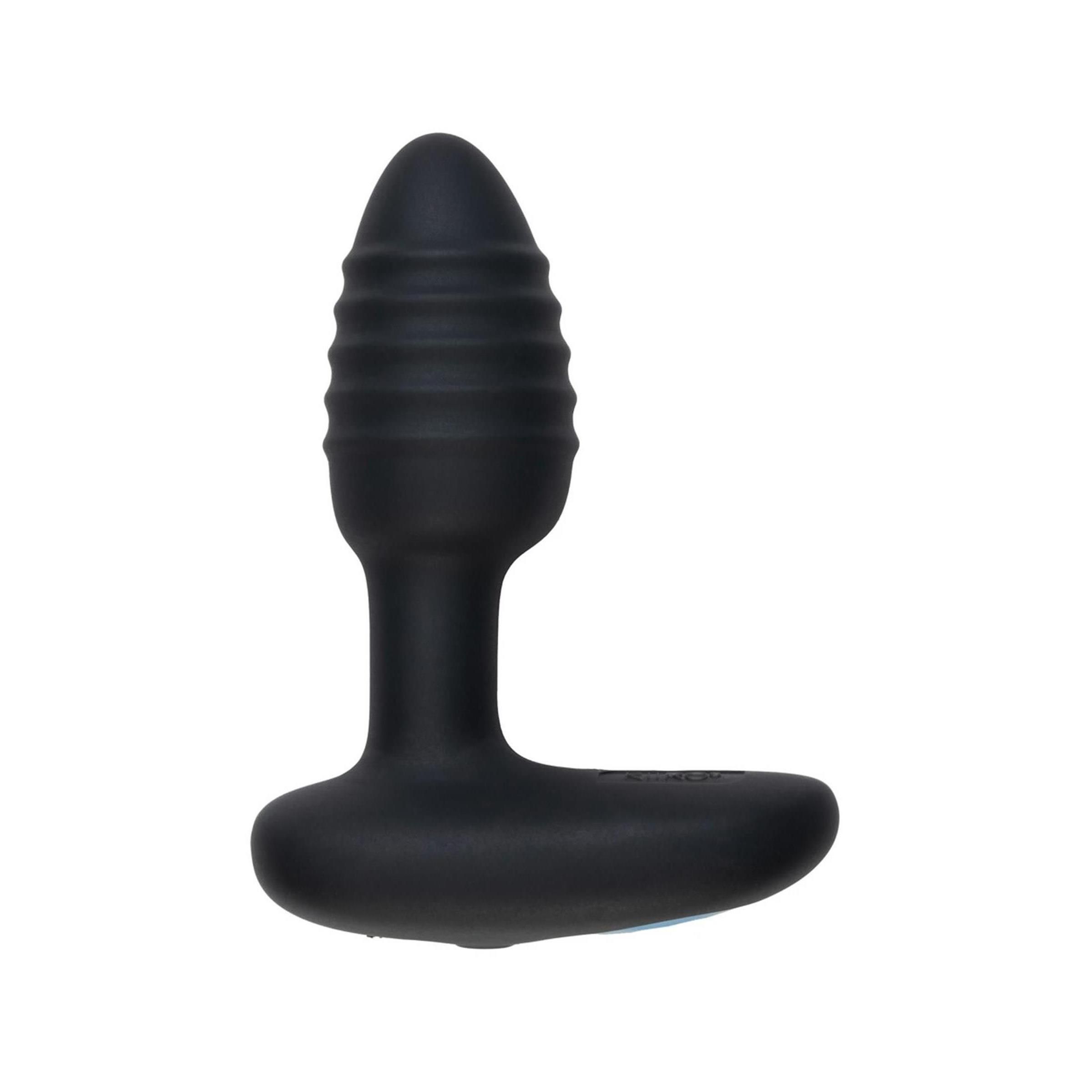 Schwarzes Wellness-Produkt mit geriffelter Spitze und T-förmigem Griff. Das Produkt steht aufrecht.