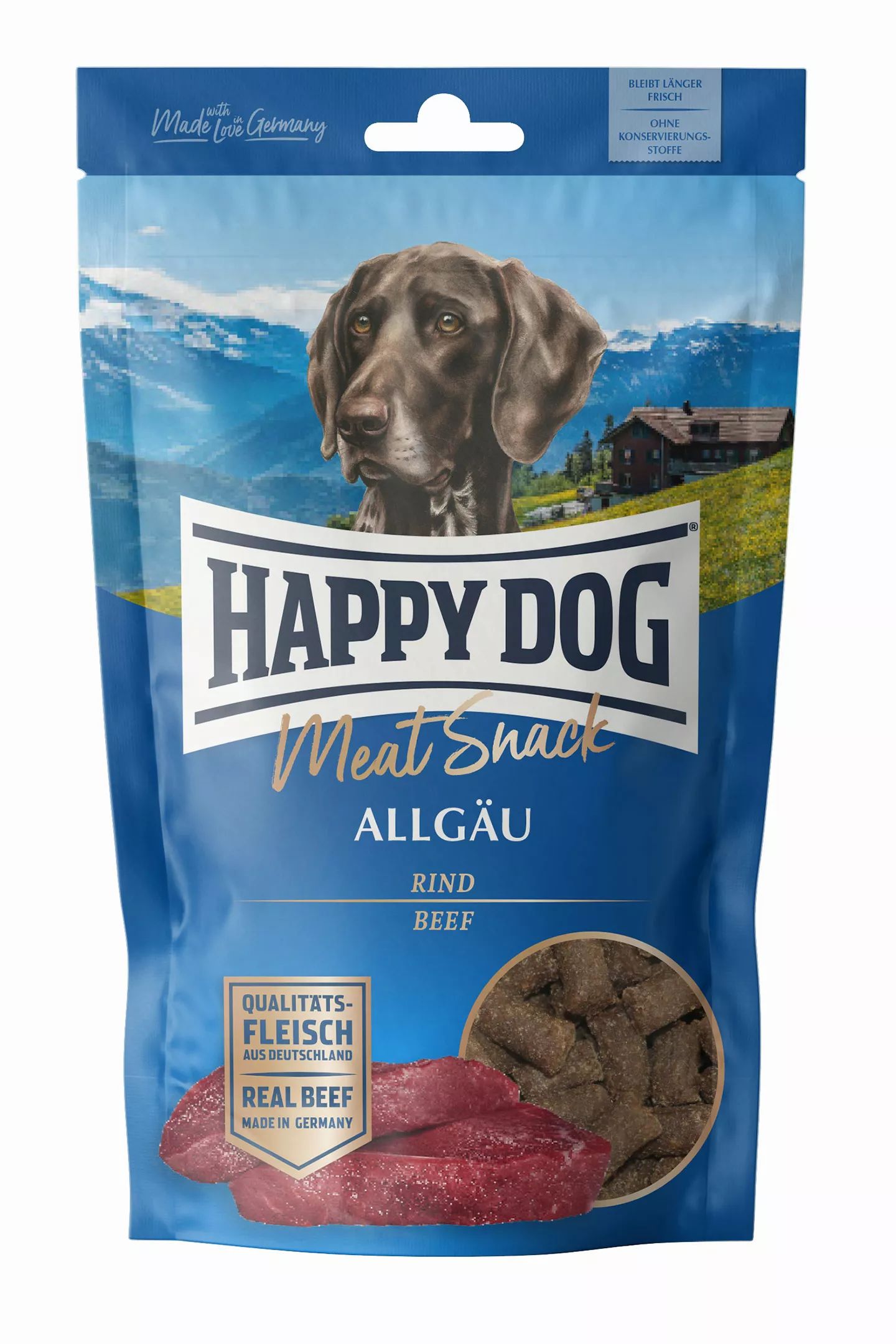 Blau-weiße Verpackung mit Hundebild. Text: Happy Dog Meat Snack Allgäu, Rind. Sichtbar: Fleischstücke und Snack-Stücke.