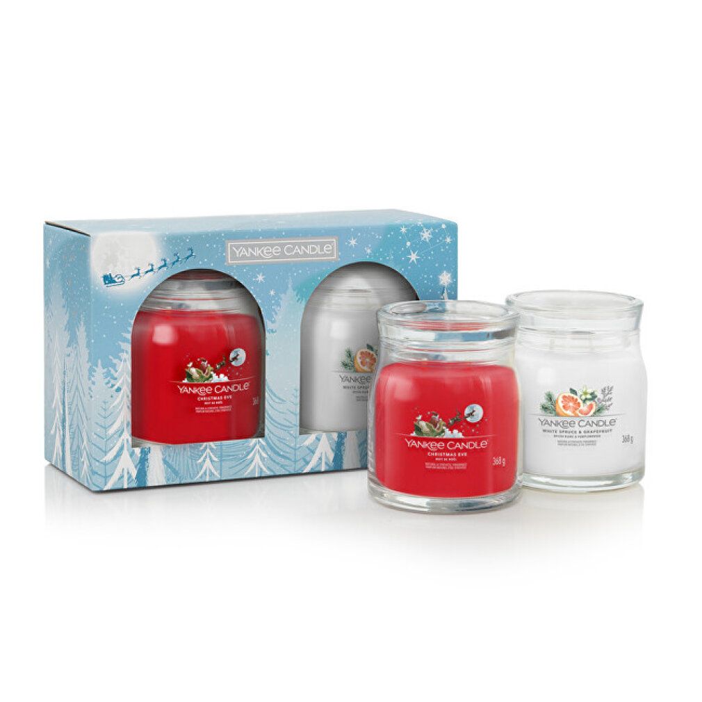 Geschenkset mit zwei Kerzen in Glasbehältern. Rote und cremefarbene Kerze in weihnachtlicher Verpackung. Marke Yankee Candle.