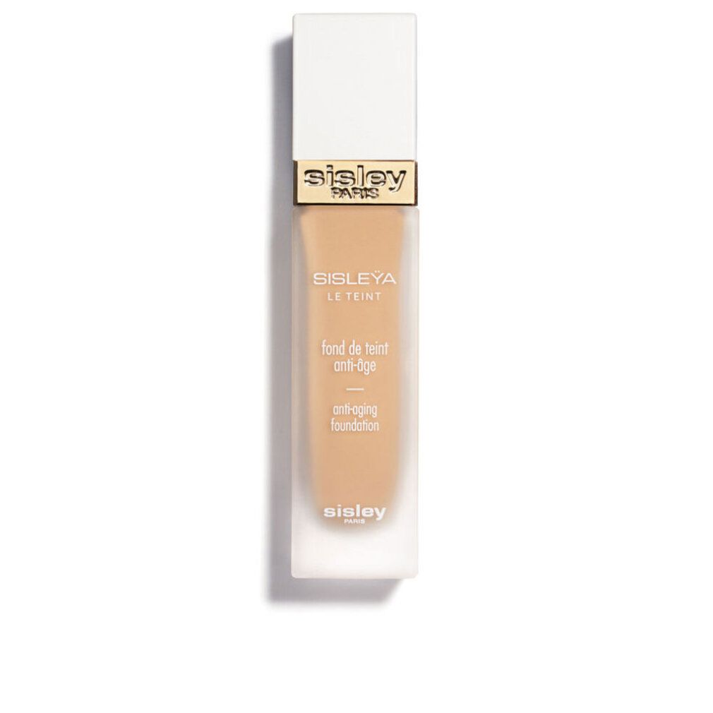 Sisley Sisleya Le Teint Foundation. Rechteckige Flasche mit weißem Deckel. Goldener Schriftzug Sisley Paris. Anti-Aging-Foundation.