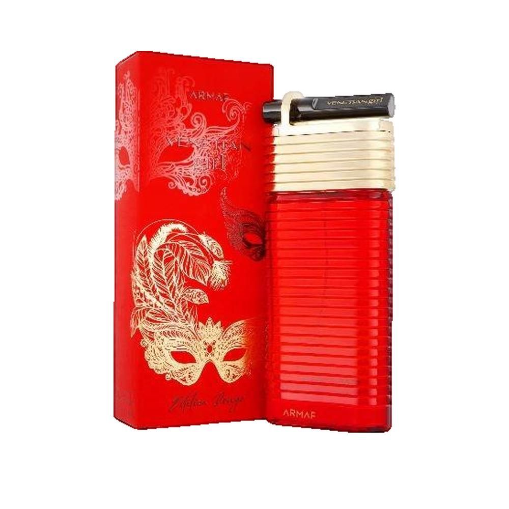 Roter Flakon mit goldfarbenem Deckel und schwarzem Verschluss. Rote Verpackung mit goldenen Masken-Illustrationen und Schriftzug.