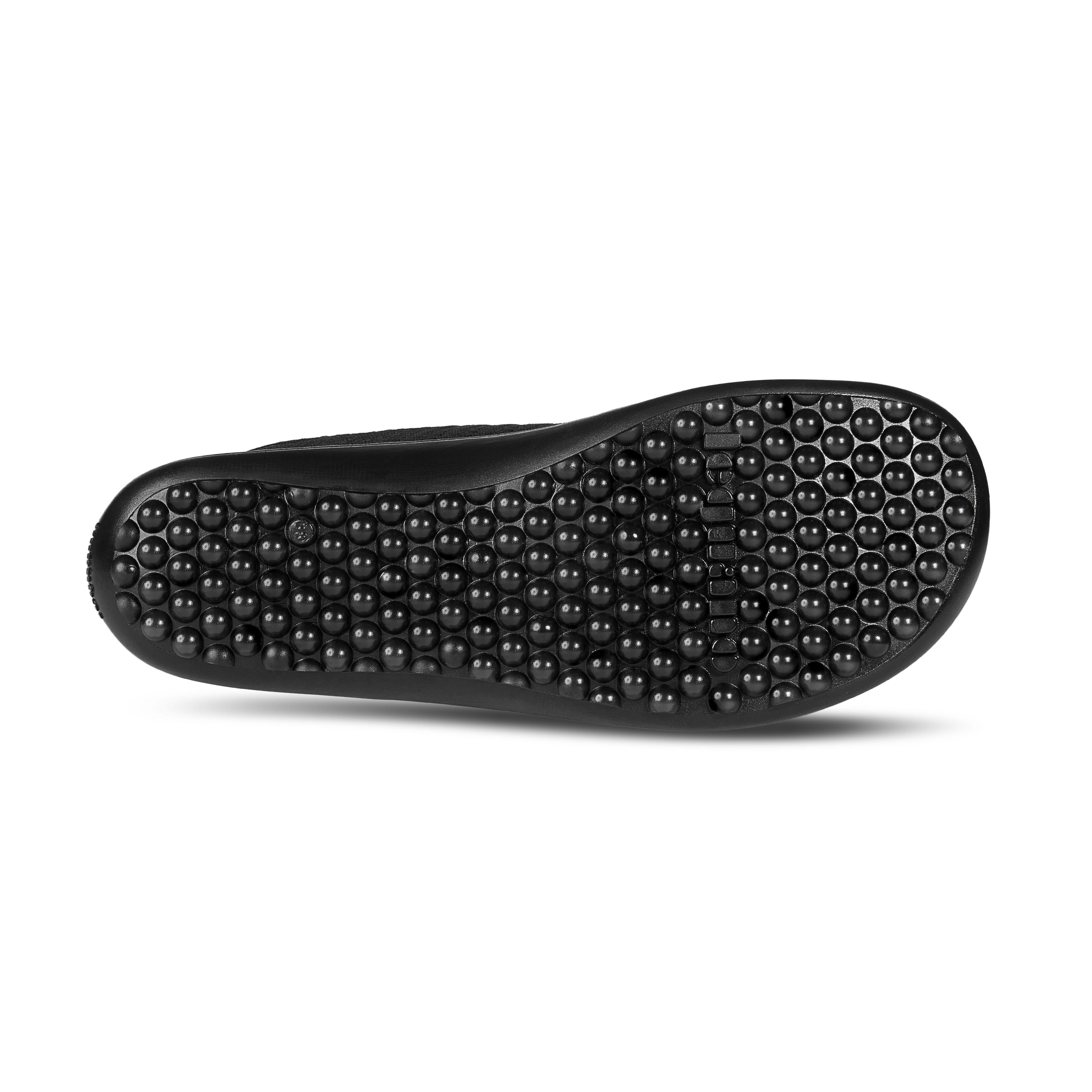 Schwarze Schuhsohle mit Noppen. Die Sohle ist für einen Barfußschuh.