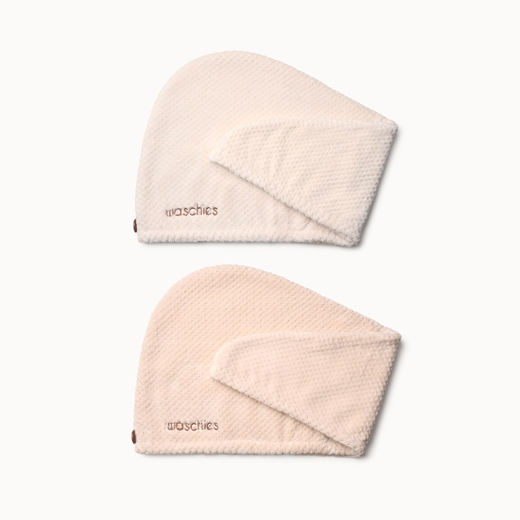 Zwei Mikrofaser-Haarturbane in Beige. Auf jedem steht "waschies". Die Turbane haben eine Kapuzenform.