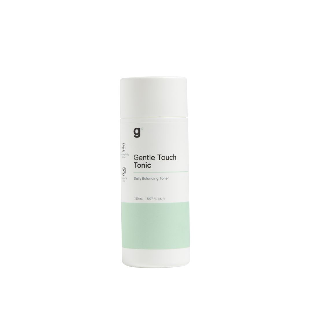Zylindrische Flasche mit grünem Band. Aufschrift: Gentle Touch Tonic. Marke: g.