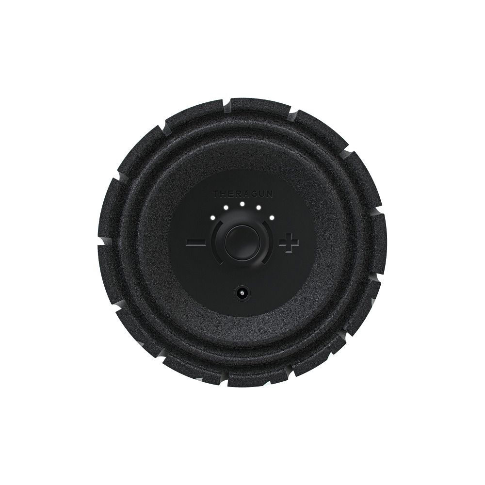 Schwarze Vibrationsmassage-Rolle. Oberseite mit Drehknopf, Plus- und Minuszeichen.