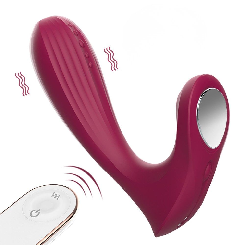 Weinroter Vibrator mit Fernbedienung. Wellenförmige Oberfläche, gebogene Form. Fernbedienung mit Knopf. 