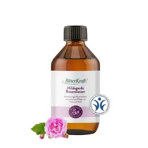 Braune Glasflasche mit schwarzem Deckel. Etikett mit Produktname und Logo. Rose und Blätter am unteren Rand. Zertifizierungslogo.