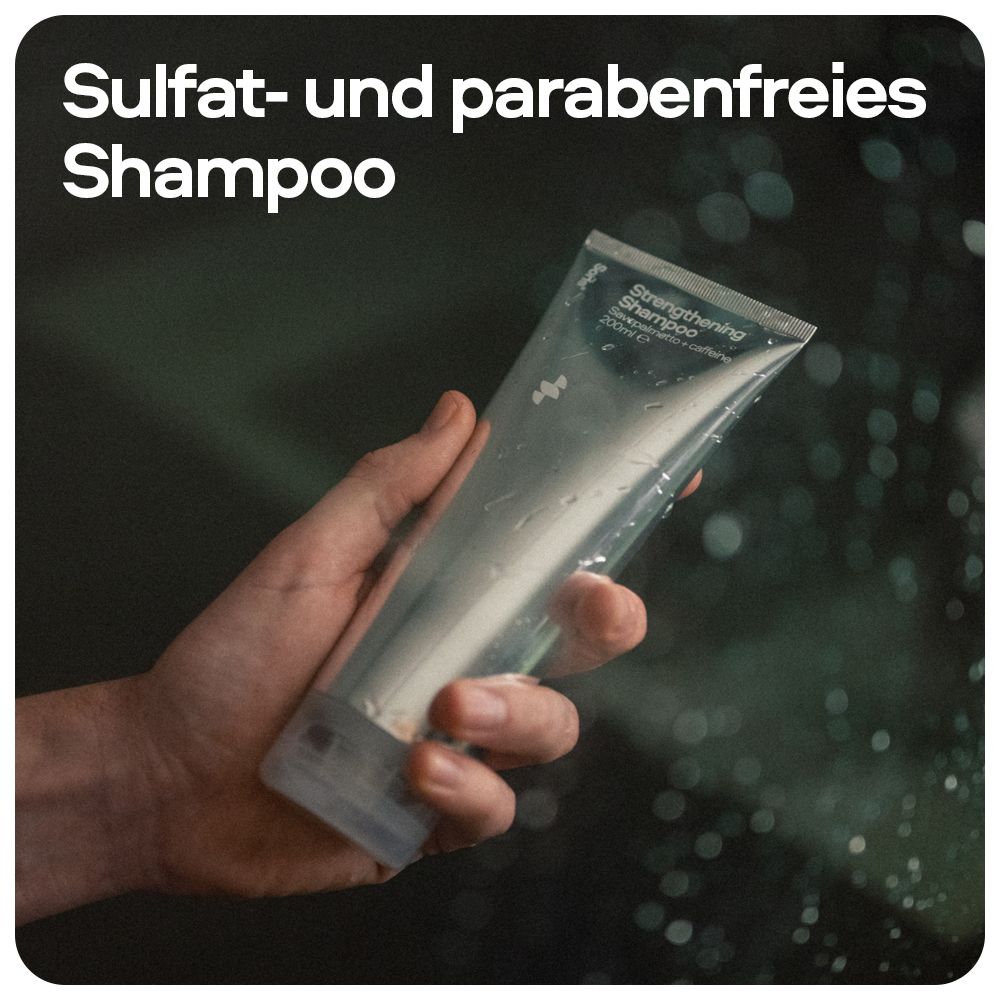 Person hält Shampoo-Tube. Aufschrift: Sulfat- und parabenfreies Shampoo. Tube transparent, silberfarben. Hintergrund: Badezimmer.
