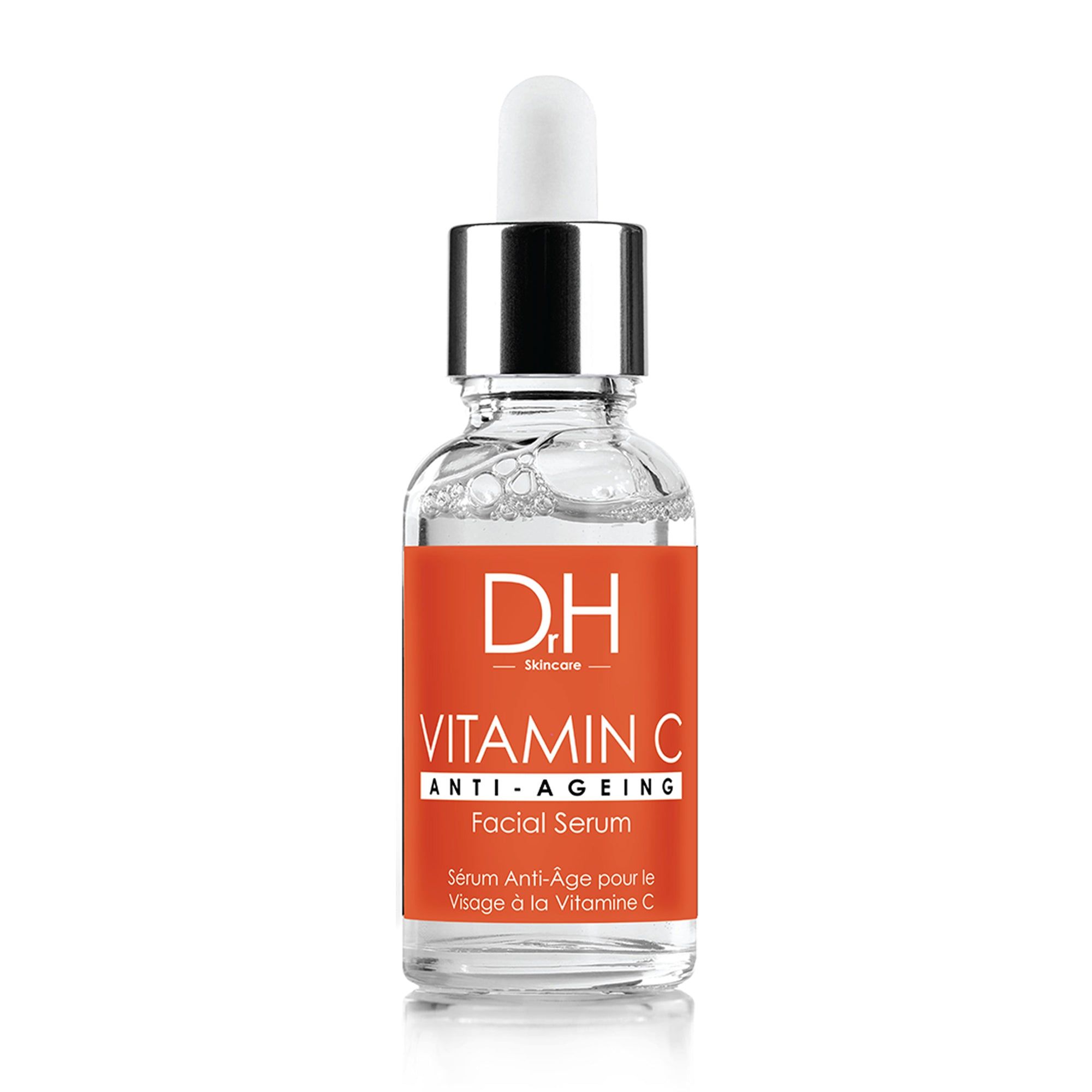 Klarflasche mit silbernem Deckel und Pipette. Orangefarbenes Etikett mit Text: Vitamin C Anti-Ageing Facial Serum.