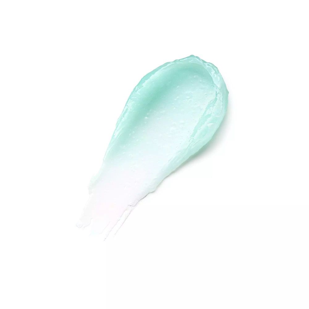 Heller, mintfarbener Lippenbalsam-Abstrich auf weißem Hintergrund. Die Textur ist cremig und glänzend.