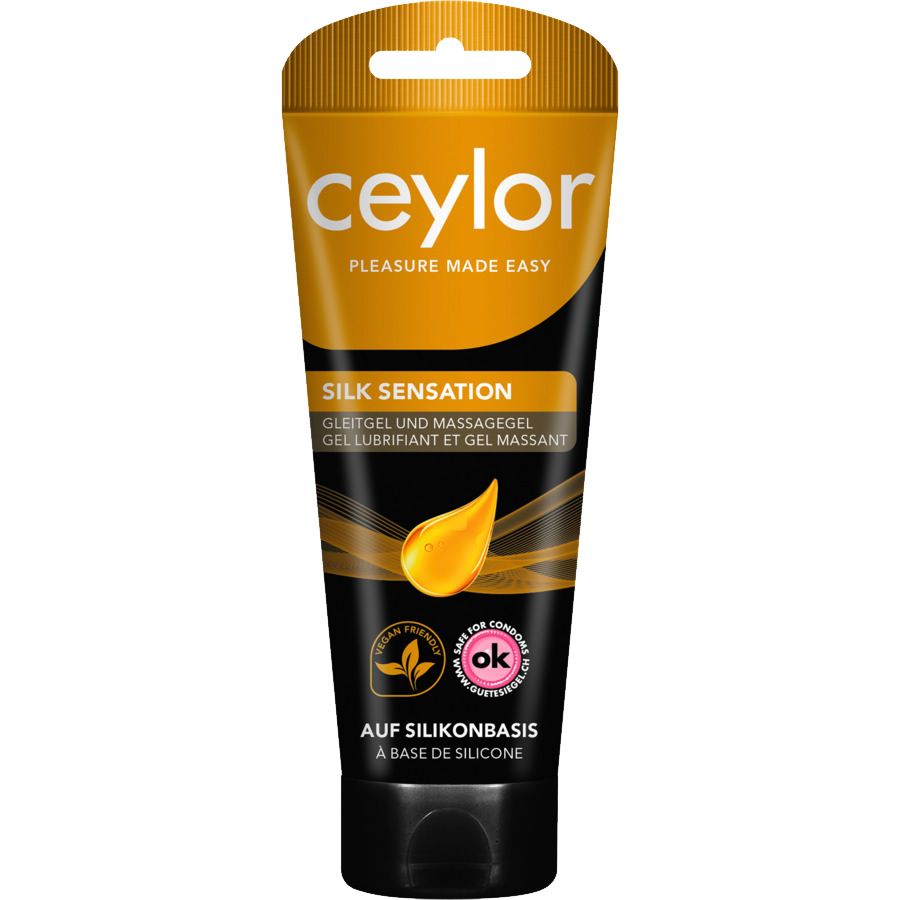 Ceylor Silk Sensation gel lubrifiant et gel massant. Le tube est principalement noir avec une partie supérieure dorée. Les mots "Silk Sensation" et "A base de silicone" sont visibles. Une goutte de gel est illustrée, ainsi que des logos pour les produits végétaliens et la sécurité des préservatifs.