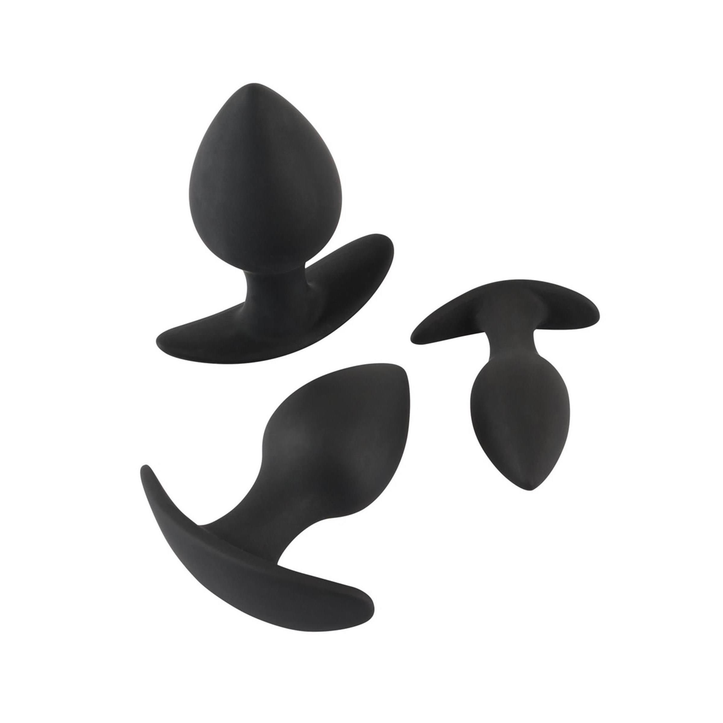 Drei schwarze Anal-Trainer. Konische Spitze, gebogene Basis. Unterschiedliche Größen.