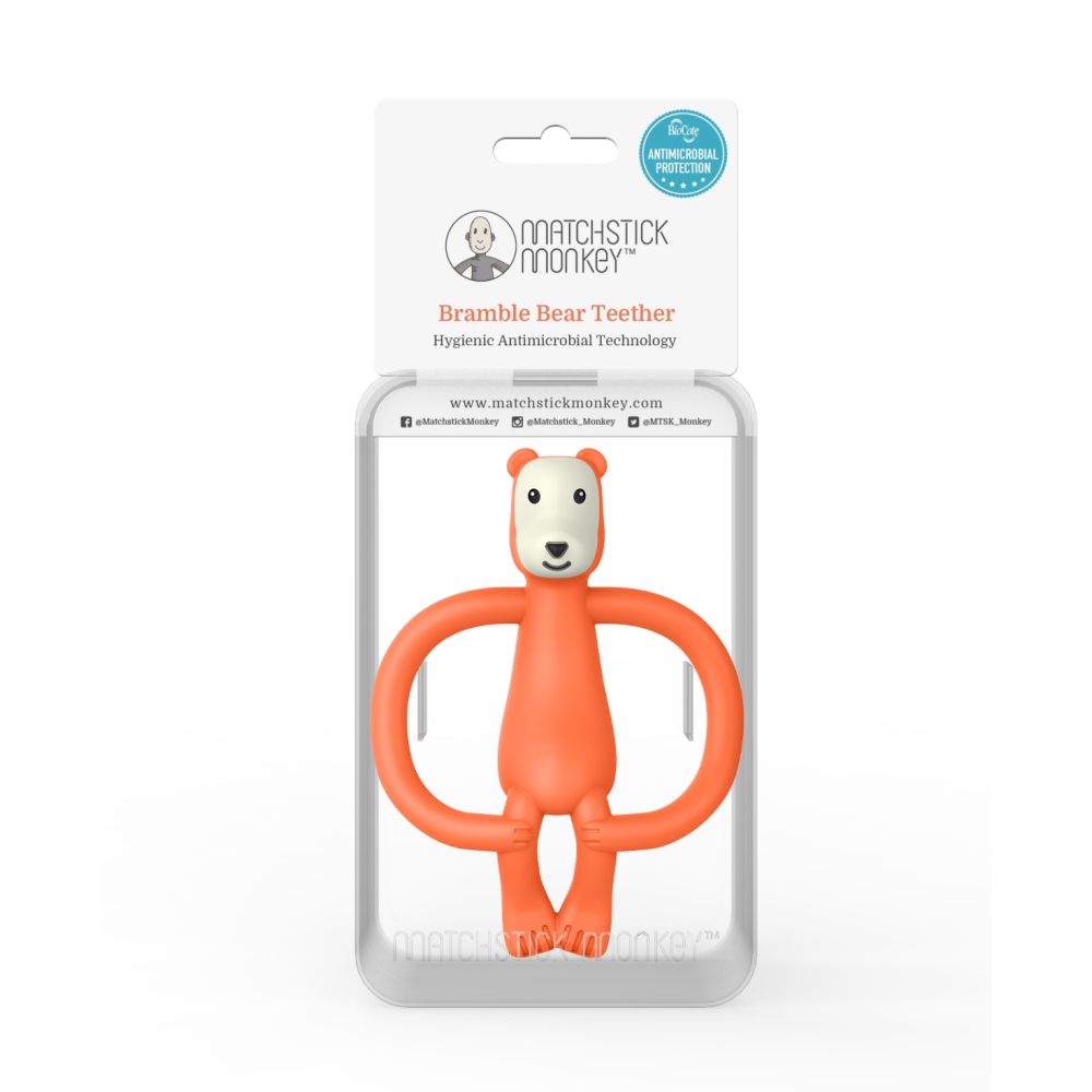 Beißring in Bärenform in Verpackung. Transparente Kunststoffverpackung mit Produktname und Logo.