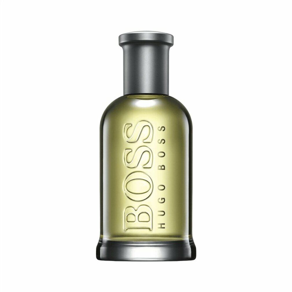 Flakon mit silbernem Verschluss. Aufschrift BOSS HUGO BOSS. Flüssigkeit gelblich.